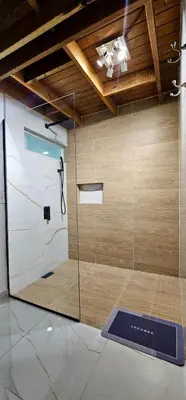 a shower with a glass door in a room at Coco house by Julio 2 in Nagua