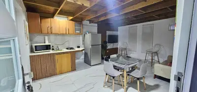 a kitchen with a table and chairs and a refrigerator at Coco house by Julio 2 in Nagua