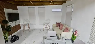 a living room with a couch and two stools at Coco house by Julio 2 in Nagua