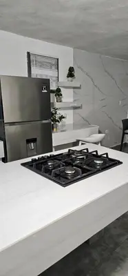 a kitchen with a stove top oven in a kitchen at Coco house by Julio in Nagua