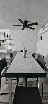 a table with a vase sitting on top of it at Coco house by Julio in Nagua