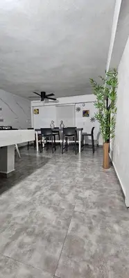 a dining room with a table and chairs and a ceiling at Coco house by Julio in Nagua