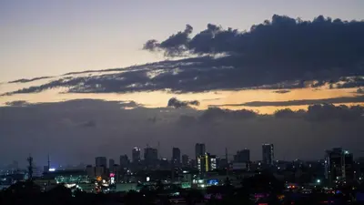 a city skyline at night with a cloudy at Cozy Loft In The Heart of Santo Domingo Este in Juan López