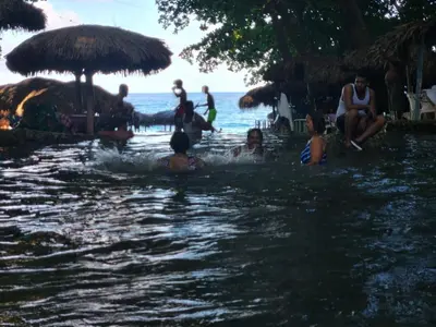 a group of people in the water at a beach at 2 Bdrm, Wi-fi, Hot Water Near Beach and River, 2R in Paraíso