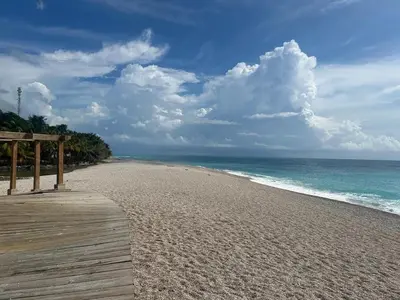 a wooden boardwalk on a beach near the ocean at 2 Bdrm, Wi-fi, Hot Water Near Beach and River, 2R in Paraíso