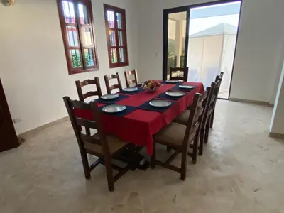 a dining room table with a red table cloth at Villa Aurora Samaná in Santa Bárbara de Samaná