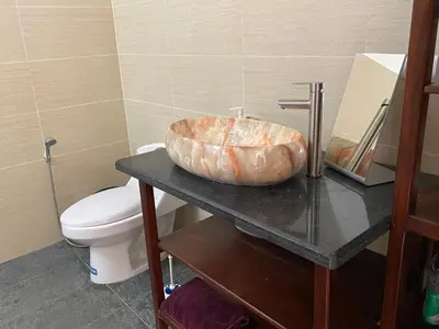 a bathroom with a sink and a toilet on a table at Villa Aurora Samaná in Santa Bárbara de Samaná
