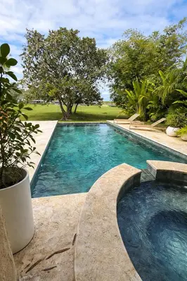 a swimming pool in a yard with trees at Villa Wolf in Punta Cana