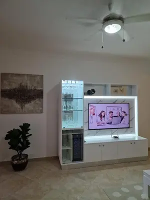 a flat screen tv sitting on top of a white cabinet at Big & classy condo at Cocotal Golf & Beach in Punta Cana