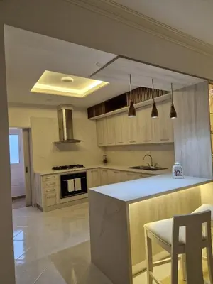 a kitchen with wooden cabinets and a white counter top at Big & classy condo at Cocotal Golf & Beach in Punta Cana