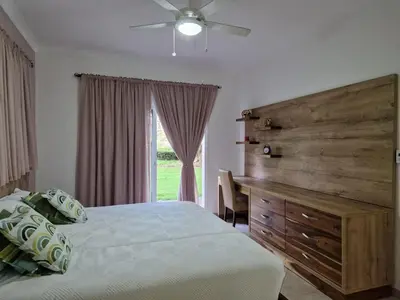 a bedroom with a bed and a dresser and a window at Big & classy condo at Cocotal Golf & Beach in Punta Cana
