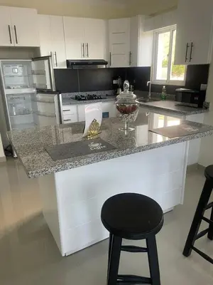 a kitchen with a counter and a black stool at 2 Bdrm, 1 Bath, Wifi, Near River and Beach, 4R, Paraiso, Barahona in Paraíso