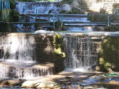 a waterfall in a park with rocks and stairs at 2 Bdrm, 1 Bath, Wifi, Near River and Beach, 4L, Paraiso, Barahona in Paraíso