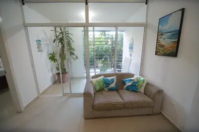 a living room with a couch and a window at franchecis hostal cerca del mar in Juan Dolio