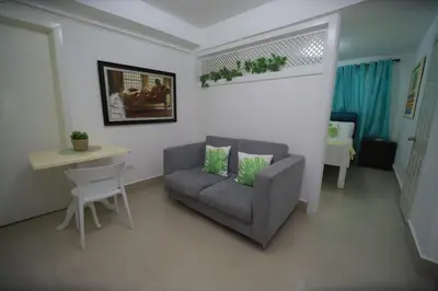 a living room with a couch and a table at Horizonte Marino En De Franchecis Hostal in Juan Dolio