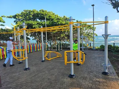 a man and a boy playing on a playground at Beautiful Oceanfront Apartment Private Balcony in San Felipe de Puerto Plata