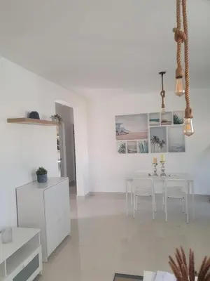 a white living room with a white table and chairs at Wohlfühloase in der Karibik in Punta Cana