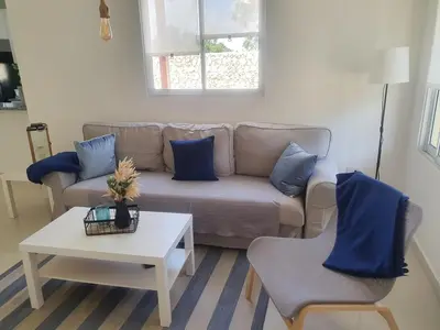 a living room with a couch and two chairs and a table at Wohlfühloase in der Karibik in Punta Cana