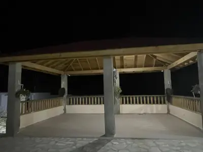 a pavilion at night with the lights on at Villa A&J in Santa Cruz de Barahona