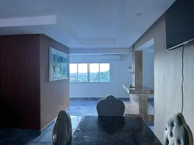 a living room with a table and chairs and a window at Comodidad, descanso y una vista que inspira in Miches