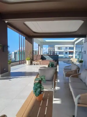 a living room with chairs and tables on a balcony at a wonderful apt, close to everything you need in Santo Domingo