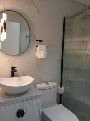 a bathroom with a sink and a toilet and a mirror at a wonderful apt, close to everything you need in Santo Domingo
