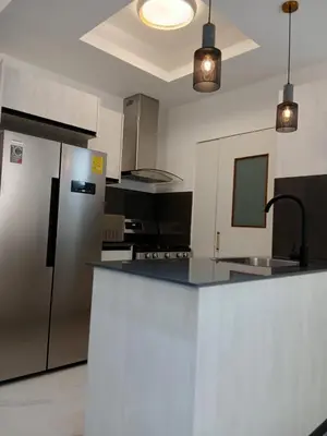 a kitchen with a stainless steel refrigerator and a counter at a wonderful apt, close to everything you need in Santo Domingo