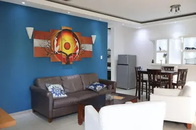 a living room with a couch and a table at Cozy apartment AC, Hot Water, WiFi, Pool, Bar, Bani 203 in Baní