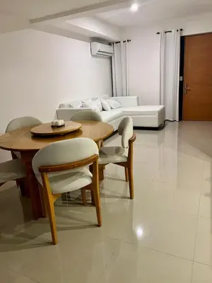 a living room with a table and chairs and a couch at Laggo one houses in Punta Cana