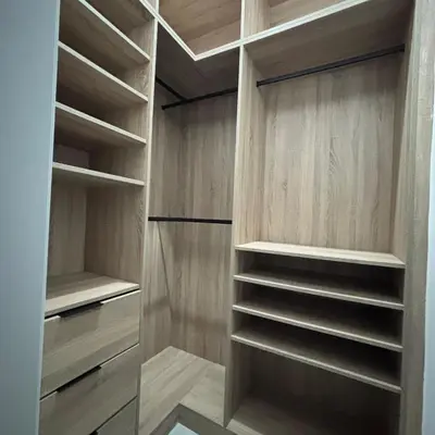 a walk in closet with wooden cabinets and shelves at Your space luxury in naco in Colorado