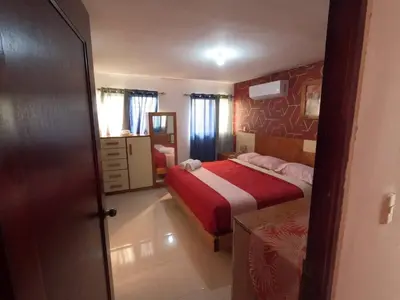 a small bedroom with a bed and a mirror at Charming 2-Bedroom Apartment with Stunning Views in Santiago in Santiago de los Caballeros