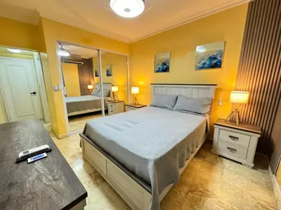a bedroom with a bed and a large mirror at Dreamvillage in Boca Chica