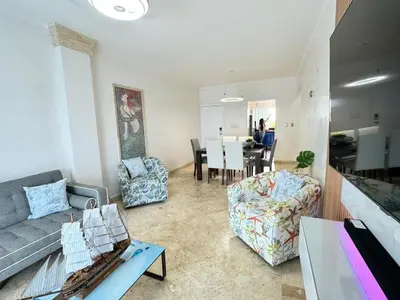 a living room with a couch and a dining room at Dreamvillage in Boca Chica