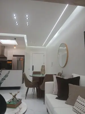a living room with a white couch and a table at Downtown, Cozy and Modern! in Santo Domingo