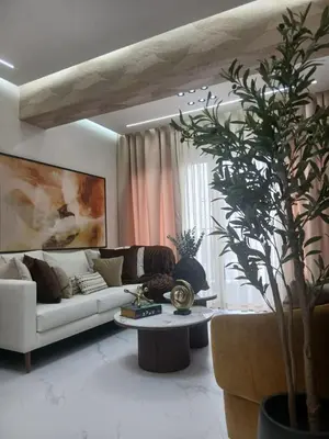 a living room with a white couch and a table at Downtown, Cozy and Modern! in Santo Domingo