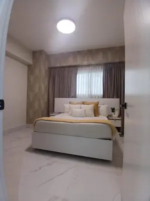 a bedroom with a large bed and a window at Downtown, Cozy and Modern! in Santo Domingo