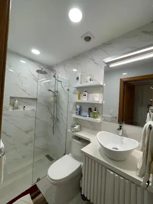 a bathroom with a toilet and a sink and a shower at Oceanfront apartment with views and pool in Los Corrales