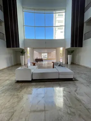 a large living room with a couch and a large window at Oceanfront apartment with views and pool in Los Corrales