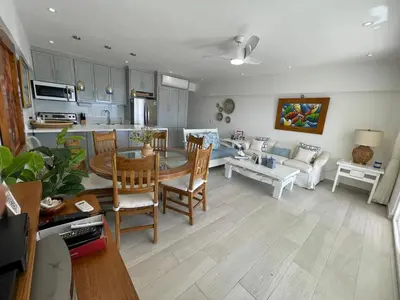 a kitchen and living room with a table and chairs at Oceanfront apartment with views and pool in Los Corrales