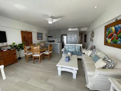 a living room with a couch and a table at Oceanfront apartment with views and pool in Los Corrales
