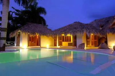 a villa with a swimming pool at night at Grandi spazi vista mare piscina infinity con grotta taina in Las Terrenas