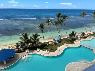 a view of a resort with a pool and the ocean at Beach Front Condo!