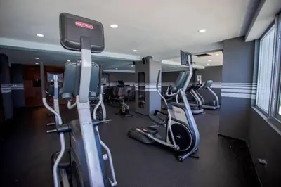 a gym with several exercise bikes in a room at Beach Front Condo!