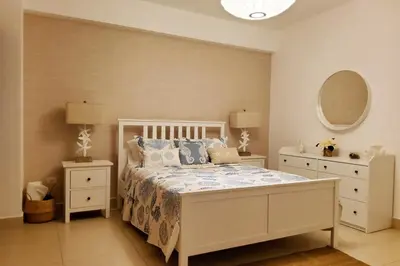 a bedroom with a white bed and two night stands at Beach Front Condo!