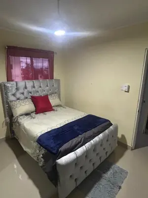 a bedroom with a bed with a red pillow on it at Garden view paradise in Concepción de La Vega