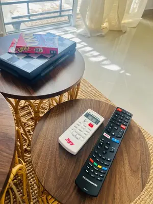 a remote control sitting on a table next to a remote control at Residencial Larimar 1 - Steps from Bayahíbe Beach in Bayahibe