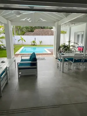 a patio with a table and chairs and a pool at Villa Exceptional location - Las Ballenas in Las Terrenas
