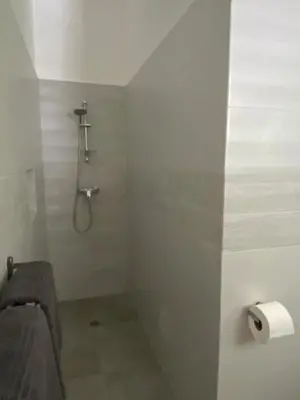 a bathroom with a shower and a toilet paper roll at Villa Exceptional location - Las Ballenas in Las Terrenas