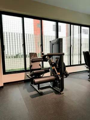 a gym with two chairs in front of large windows at Relaxing & New Retreat 3 bedroom riviera Verde in Santo Domingo