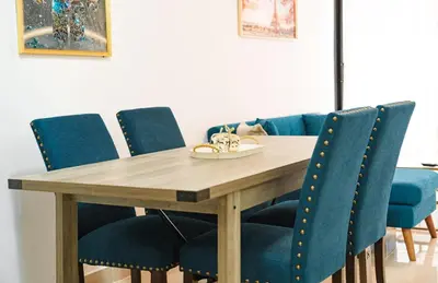 a dining room table and chairs with blue chairs at Relaxing & New Retreat 3 bedroom riviera Verde in Santo Domingo